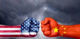 Two fists painted as USA and China flags