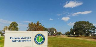 Federal Aviation Administration sign on grassy lawn.