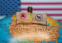 Republican and Democratic flags on USA map background.