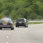 Police car pursuing another vehicle on highway