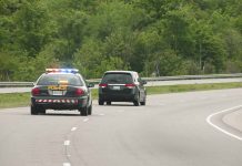 Police car pursuing another vehicle on highway