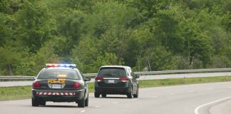Police car pursuing another vehicle on highway