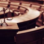 Scales of justice in an empty courtroom.