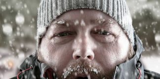Man in snow with beard and knit hat