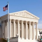 United States Supreme Court building with American flag