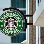 Starbucks coffee shop sign on building.
