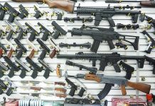 Wall display of various firearms in a store