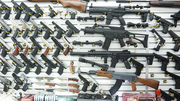 1096565825 featured image Wall display of various firearms in a store
