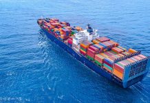 Cargo ship carrying colorful containers in open sea