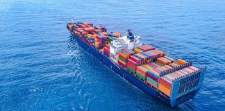 Cargo ship carrying colorful containers in open sea