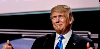 Trump giving thumbs-up gesture on stage