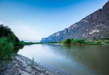 River with mountains and greenery in the background