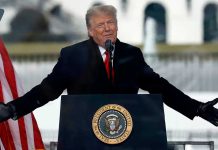 Trump speaking at a podium with microphones