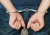 Person in handcuffs behind their back