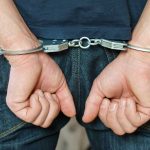 Person in handcuffs behind their back
