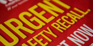 Urgent safety recall sign in bold letters.