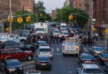 Police activity on a city street with emergency vehicles