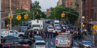 Police activity on a city street with emergency vehicles