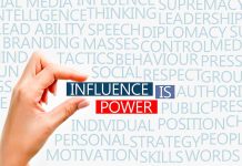 Hand holding block text influence is power