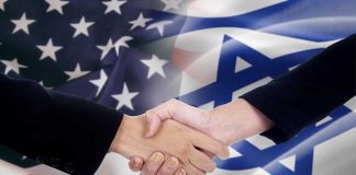 Handshake in front of US and Israeli flags