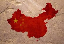 Map of China with flag on textured wall