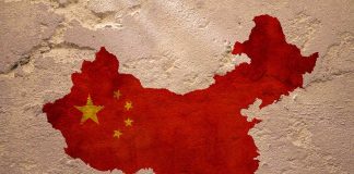 Map of China with flag on textured wall