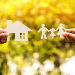 Paper cutouts of a house and family outdoors