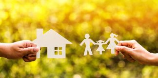 Paper cutouts of a house and family outdoors