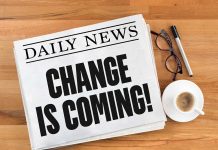 Newspaper headline Change Is Coming on table
