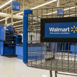Walmart shopping cart inside store near checkout aisle