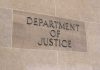 Department of Justice building sign on wall