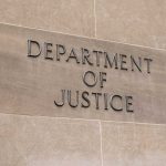 Department of Justice building sign on wall