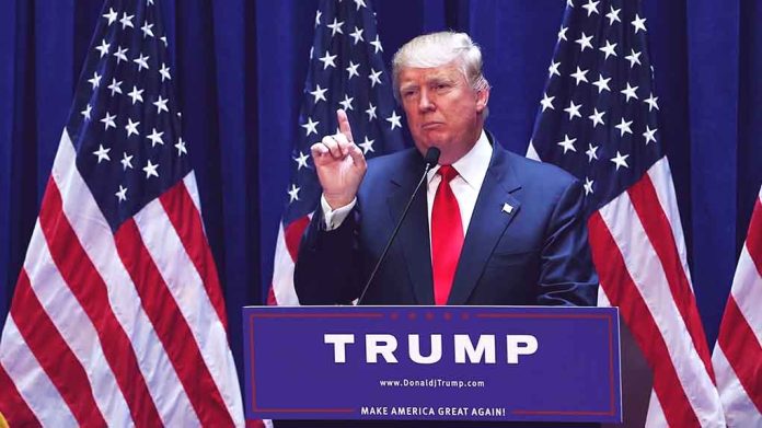 1456399979 featured image Person speaking at podium with multiple American flags