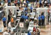 Airport security checkpoint with passengers and staff busy