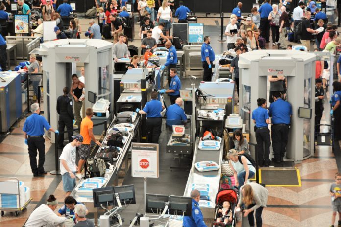 1463547920 featured image Airport security checkpoint with passengers and staff busy