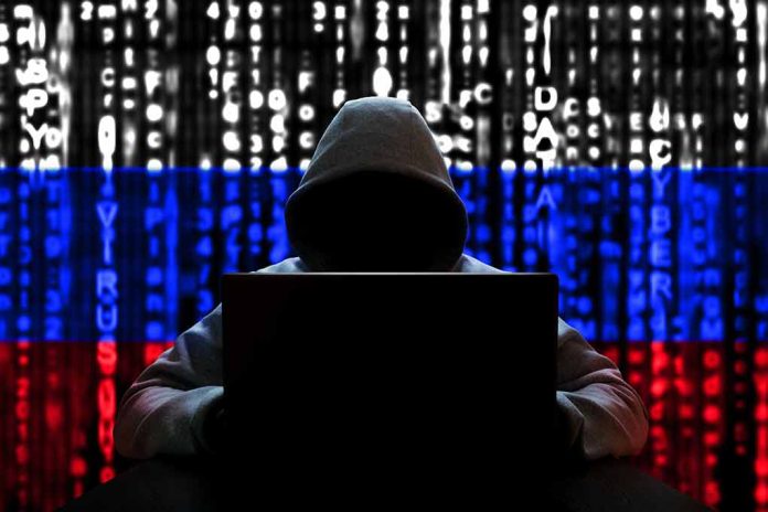 1654709008 featured image Hacker in hoodie with Russian flag background and code
