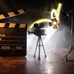 Film set with clapperboard camera and lighting