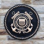 United States Coast Guard emblem on stone wall.
