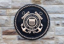 United States Coast Guard emblem on stone wall.