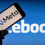 Meta logo on phone Facebook background display