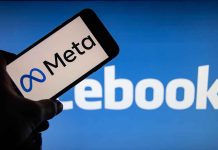 Meta logo on phone Facebook background display