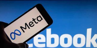 Meta logo on phone Facebook background display