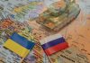 Tank on map with Ukrainian and Russian flags