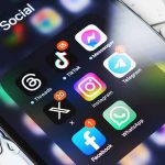 Smartphone showing social media app icons in a folder