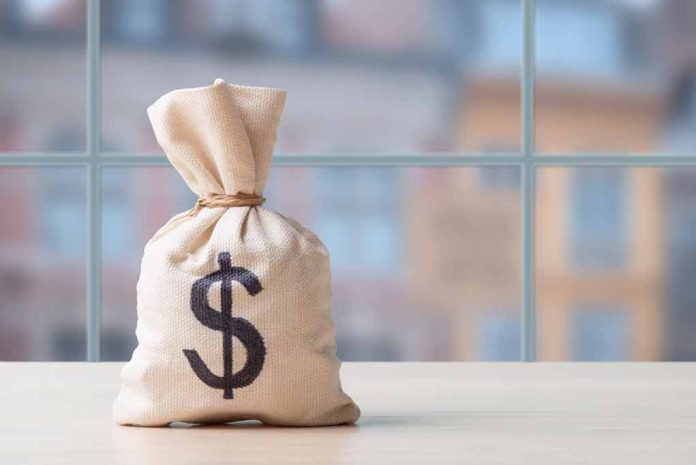 2425646037 featured image Money bag wit0000000000000000000000000000000000000h dollar sign on table