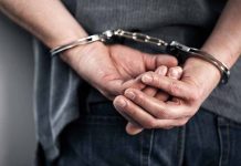 Person in handcuffs with hands behind back