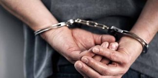 Person in handcuffs with hands behind back