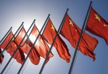 Red flags with yellow stars on flagpoles