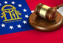 Georgia flag and judges gavel on wooden base