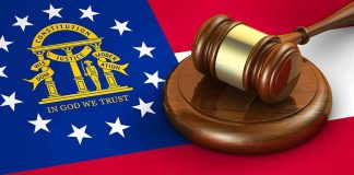 Georgia flag and judges gavel on wooden base